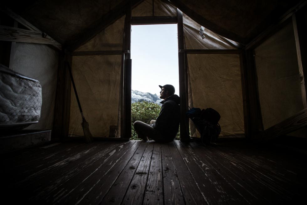 Man in doorway of cabin