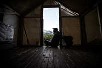 Man in doorway of cabin